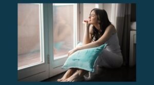 Pretty woman sat on the floor by a folding patio door, with all the time in the world